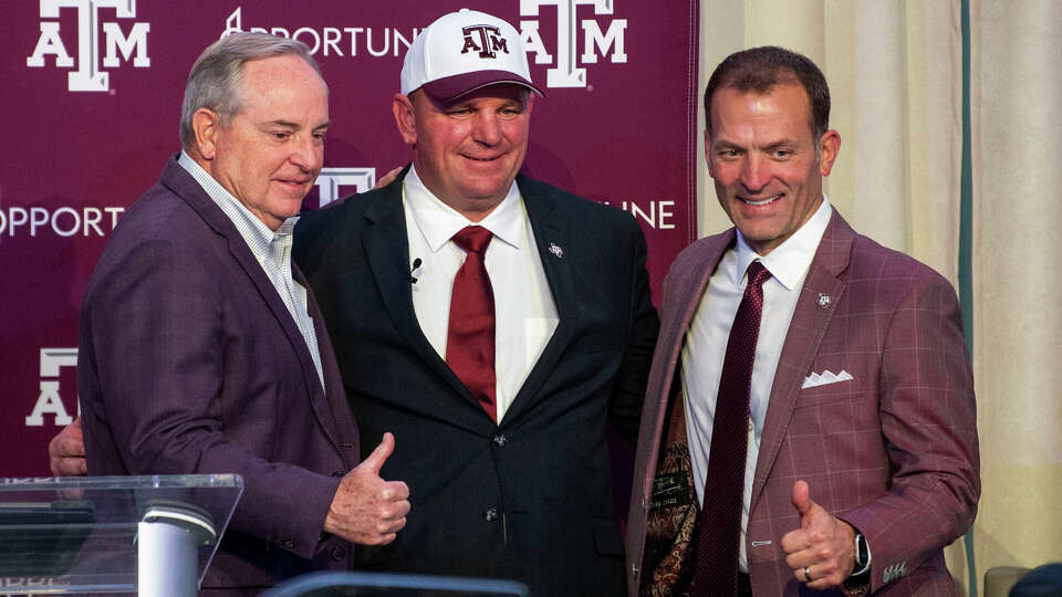 New Texas A&M coach Mike Elko, with athletic director Ross Bjork (right) and school president Mark Welsh (left), takes over an Aggies program with the clear expectation to win now, not years down the road, in the SEC with Texas and Oklahoma arriving next season.