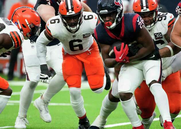 Houston Texans running back Devin Singletary (26) makes the first down while Cleveland Browns are tackling him during the second quarter of a NFL game on Sunday, Dec. 24, 2023 at NRG Stadium in Houston.