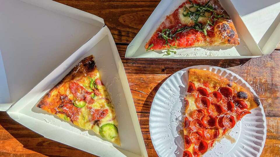 Slices of sausage, clockwise left, margherita and pepperoni pizzas from Neighbors, a restaurant in the East End, on Dec. 27, 2023.