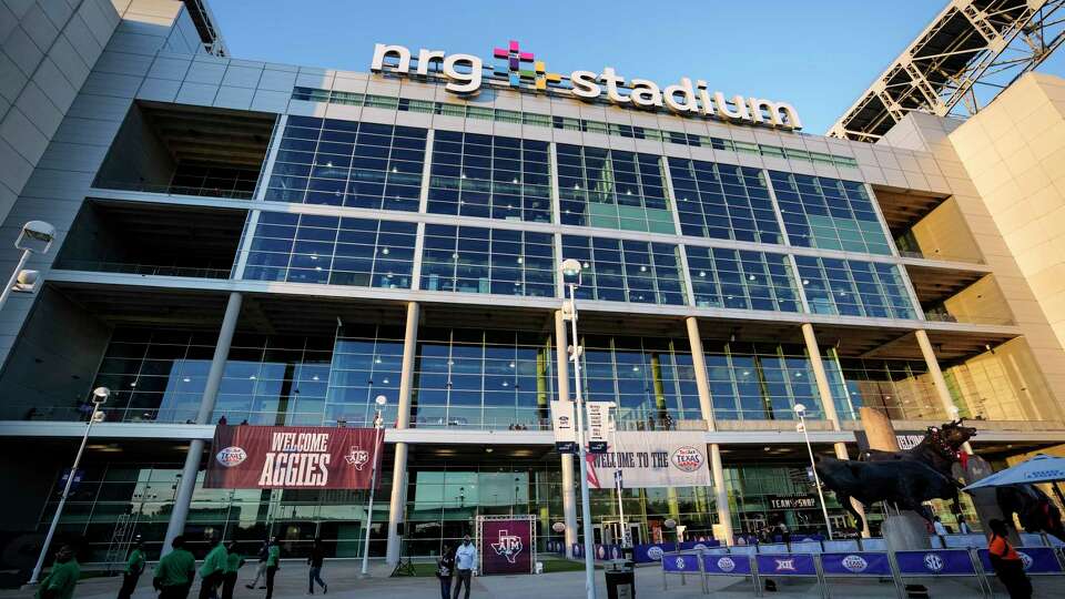 Fan mingle outside NRG Stadium before the Tax Act Texas Bowl on Wednesday, Dec. 27, 2023 in Houston.