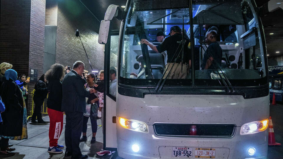 FILE — Adult and children asylum seekers arrive on a bus from El Paso, Texas, to NYC Porth Authority in New York on May 3, 2023. 