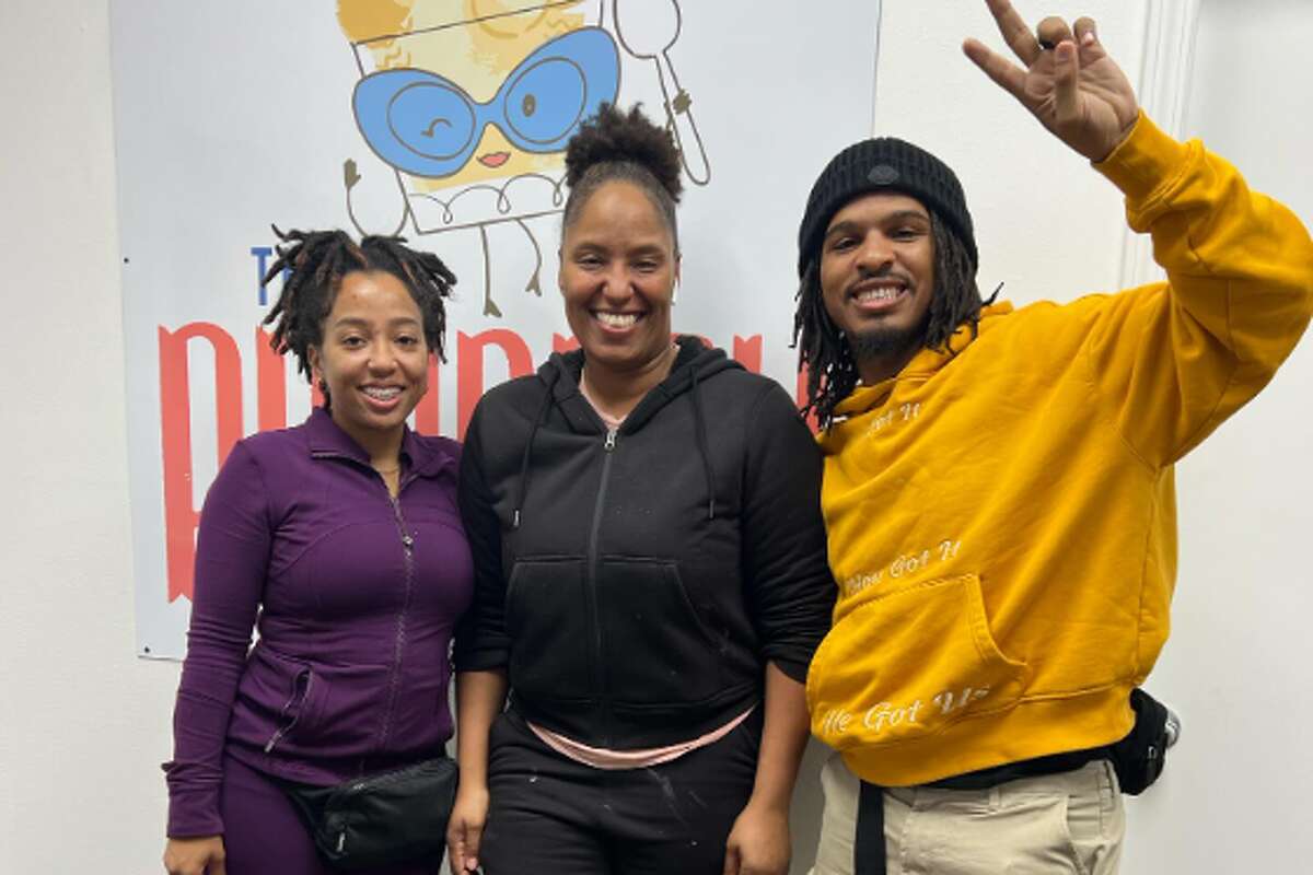 Janel Prator, owner of The Puddery, center, poses with Ronni and Keith Lee at her Pearland shop.