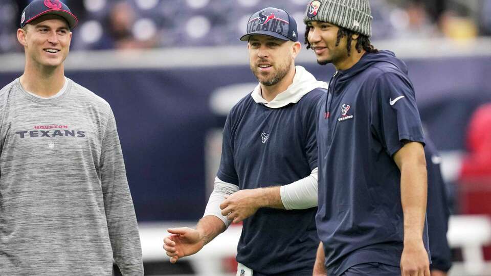 Houston Texans quarterbacks Davis Mills, left, Case Keenum and C.J. Stroud warm up before an NFL football game against the Tennessee Titans on Sunday, Dec. 31, 2023, in Houston.