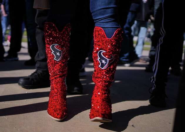 A Houston Texans fans wears her boots during a pep assembly before the her team takes on the Tennessee Titans at NRG Stadium on Sunday, Dec. 31, 2023 in Houston.