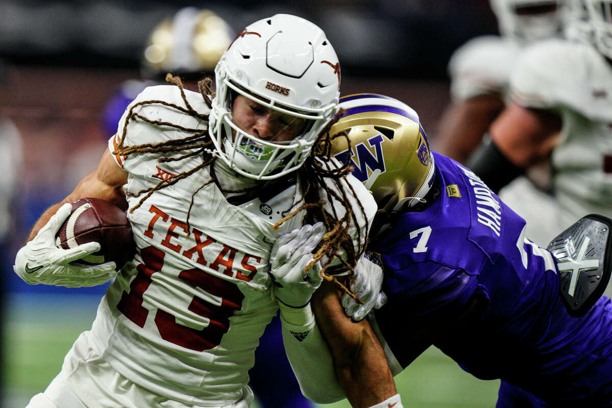 Texas wide receiver Jordan Whittington (13) runs against Washington cornerback Dominique Hampton (7) during the first half of the Sugar Bowl CFP NCAA semifinal college football game, Monday, Jan. 1, 2024, in New Orleans. (AP Photo/Jacob Kupferman)