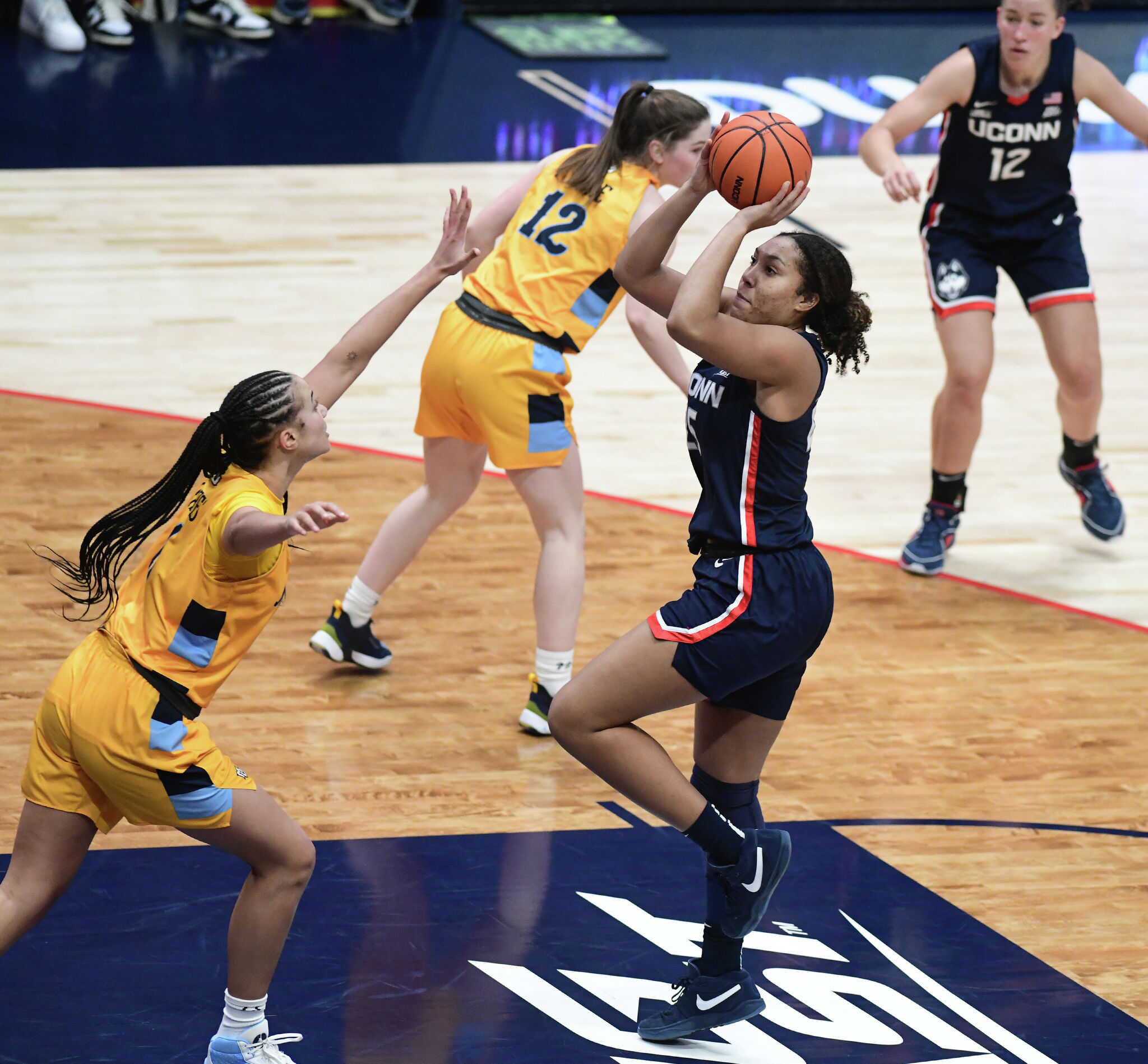 UConn women's basketball's Aaliyah Edwards helped by Ice Brady