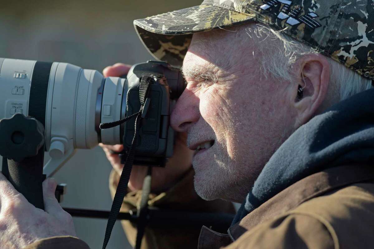 Bob O’Donnell, of Guilford, looks to capture a photograph of a bald eagle at the Shepaug Eagle Observatory on Wednesday, Jan. 3, 2024, in Southbury, Conn. The observatory is now open for its 38th season, offering residents a unique opportunity to view bald eagles in their natural habitat. The observatory is run by FirstLight, which owns and operates the Shepaug Hydro Generating Station in Southbury. 