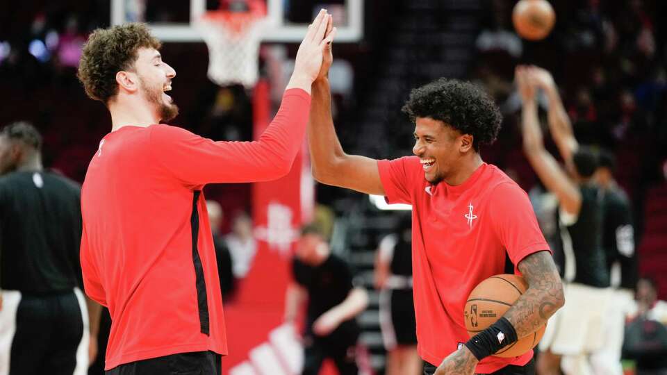 Houston Rockets center Alperen Sengün, left, shares a laugh with guard Jalen Green before an NBA basketball game at Toyota Center, Wednesday, Jan. 3, 2024, in Houston.