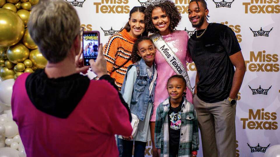 The Keys family takes the opportunity to pose for a photo with Miss Texas 2023, Ellie Breux, Wednesday, Jan. 3, 2024, at the Missouri City Community Center where friends and family gathered to show their support before Ellie departs for Orlando, Florida later this week to compete in the Miss America Pageant.