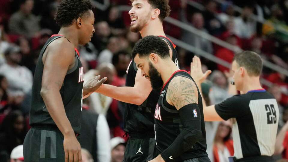 Houston Rockets center Alperen Sengün (28) reacts toward forward Jae'Sean Tate (8) as he head to the behind alongside guard Fred VanVleet (5) during the second half of an NBA basketball game at Toyota Center, Wednesday, Jan. 3, 2024, in Houston.