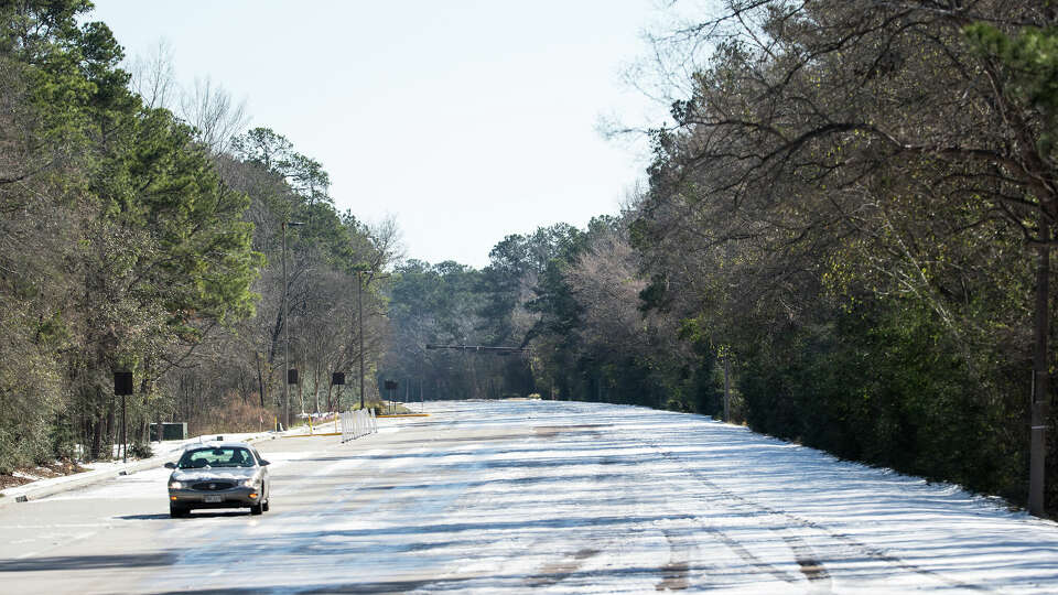 A single car drives along an empty Woodlands Parkway Tuesday, Feb. 16, 2021 in The Woodlands. Traffic continued to be light on the roadways as temperatures stayed below freezing Tuesday and roads remained icy.