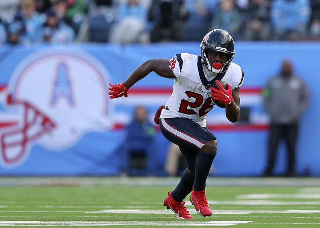 Devin Singletary #26 of the Houston Texans carries the ball during the game against the Tennessee Titans at Nissan Stadium on December 17, 2023 in Nashville, Tennessee.