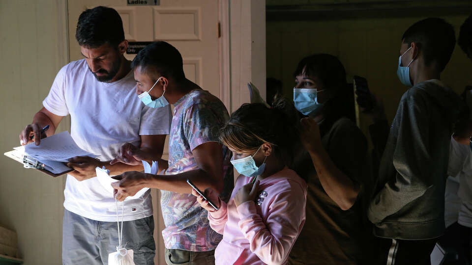 Migrants are checked in for a bus headed to San Antonio, at Mission: Border Hope in Eagle Pass, Texas, Wednesday, Sept. 21, 2022. A surge of migrants crossing has been seen in the area. Texas Gov. Greg Abbott started busing migrants from South Texas to Chicago in late August in response to what he called a lack of federal government action on the border issue. The arrival of migrants in New York City and Chicago came as a surprise. Migrants in Chicago have been housed at area hotels and the Salvation Army. After crossing the Rio Grande and surrendering to authorities, migrants are released to the shelter where they can buy a ticket to San Antonio for $50. Those with tickets to other destinations are taken to the airport or bus station in San Antonio. Those without tickets are taken to the San Antonio Migrant Resource Center.