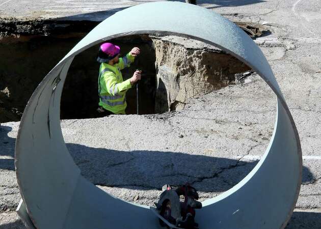 A city employee works in a hole on 51st Street in Galveston on Thursday, Jan. 4, 2024. The hole, which developed Wednesday, closed the street between Broadway and Avenue K as crews worked to repair it.