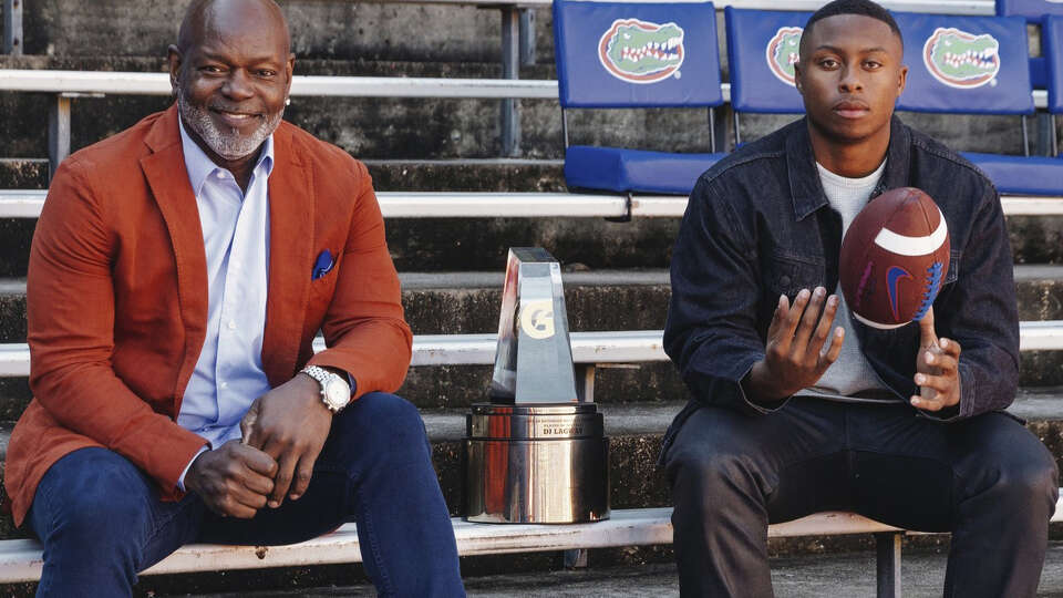 Willis' D.J. Lagway, right, is seen posing with NFL great Emmitt Smith, left, and the Gatorade National Football Player of the Year award at Ben Hill Griffin Stadium in Gainesville, Fla. on Jan. 4, 2024.