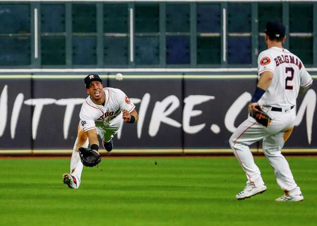 Houston Astros left fielder Michael Brantley (23) catches a line drive from New York Yankees center fielder Aaron Hicks (31) during the seventh inning of Game 6 of the American League Championship Series at Minute Maid Park in Houston on Saturday, Oct. 19, 2019. Brantley would proceed to throw out New York Yankees right fielder Aaron Judge (99) at first base to end the top of the inning.