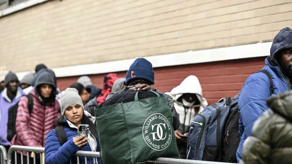 NEW YORK CITY, UNITED STATES - DECEMBER 4: Asylum seekers line up in front of the East Village re-intake, converted into a city-run shelter for newly arrived migrant families in New York City, United States on December 4, 2023. (Photo by Fatih Aktas/Anadolu via Getty Images)