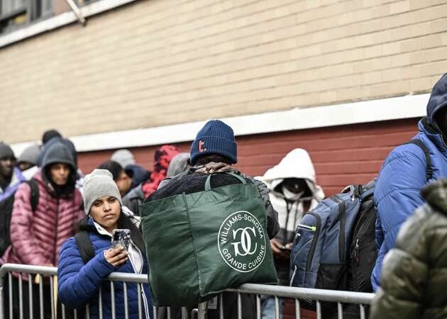 NEW YORK CITY, UNITED STATES - DECEMBER 4: Asylum seekers line up in front of the East Village re-intake, converted into a city-run shelter for newly arrived migrant families in New York City, United States on December 4, 2023. (Photo by Fatih Aktas/Anadolu via Getty Images)