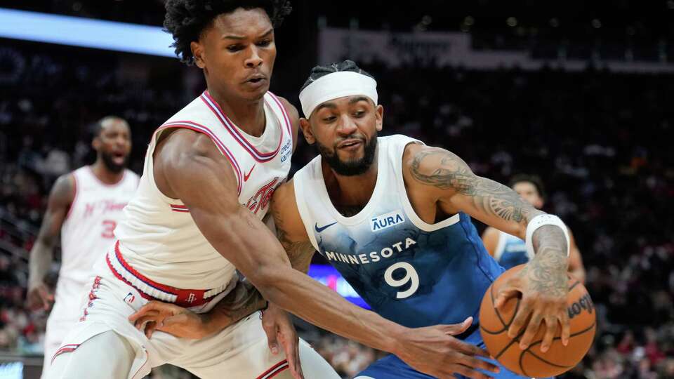 Houston Rockets forward Amen Thompson (1) tips the ball against Minnesota Timberwolves guard Nickeil Alexander-Walker (9) during the second half of an NBA basketball game at Toyota Center, Friday, Jan. 5, 2024, in Houston.