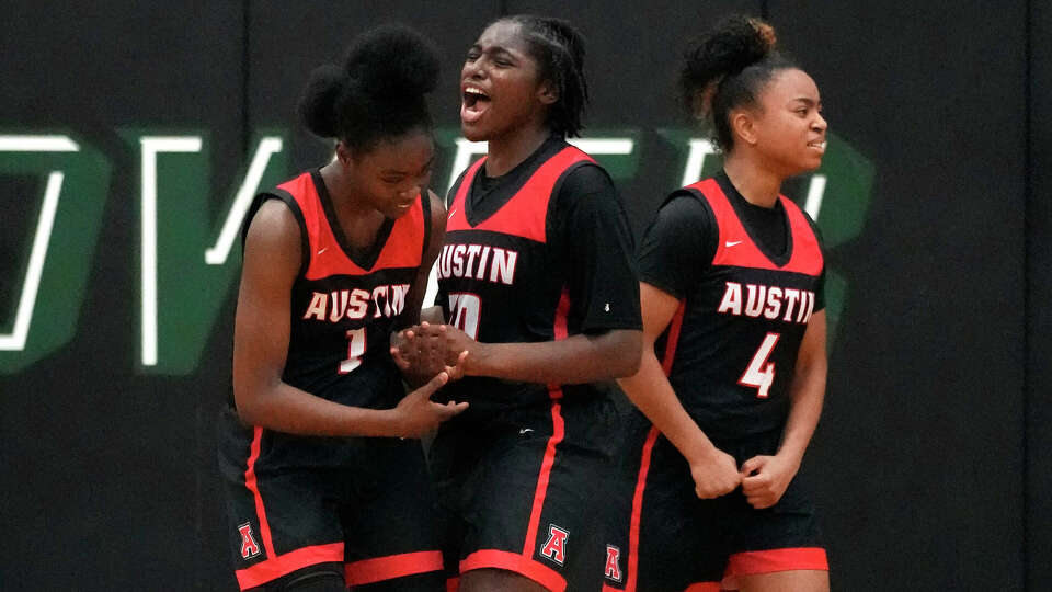 Fort Bend Austin's India Jackson (30) celebrates their win with Andrea Sturdivant (1) during the second half of a District 20-6A girls basketball game at Hightower High School on Friday, Jan. 6, 2023 in Missouri City. Fort Bend Austin beat Hightower 26-23.