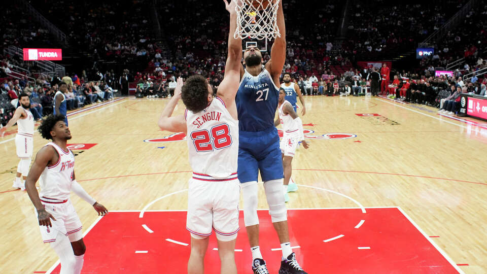 Minnesota Timberwolves center Rudy Gobert (27) dunks the ball over Houston Rockets center Alperen Sengün (28) during an NBA basketball game at Toyota Center, Friday, Jan. 5, 2024, in Houston.