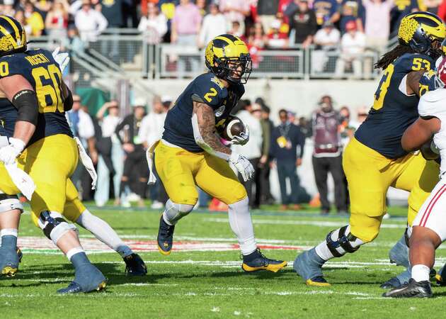 ?Blake Corum #2 of the Michigan Wolverines runs with the ball for yardage during the first half of the CFP Semifinal Rose Bowl Game against the Alabama Crimson Tide at Rose Bowl Stadium on Jan. 1, 2024 in Pasadena, California.??