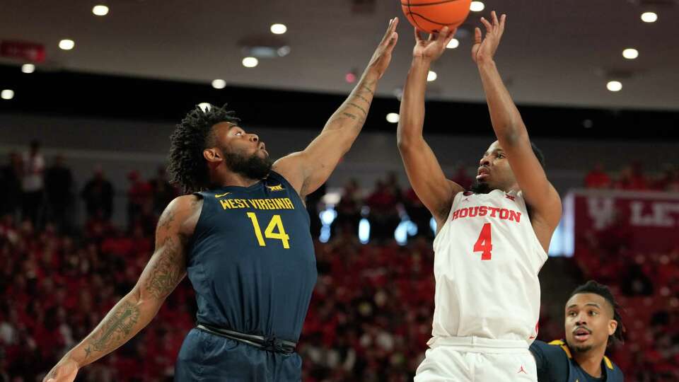 Houston Cougars guard L.J. Cryer (4) shoots over West Virginia Mountaineers guard Seth Wilson (14) during the first half of an NCAA college basketball game at the Fertitta Center, Saturday, Jan. 6, 2024, in Houston.