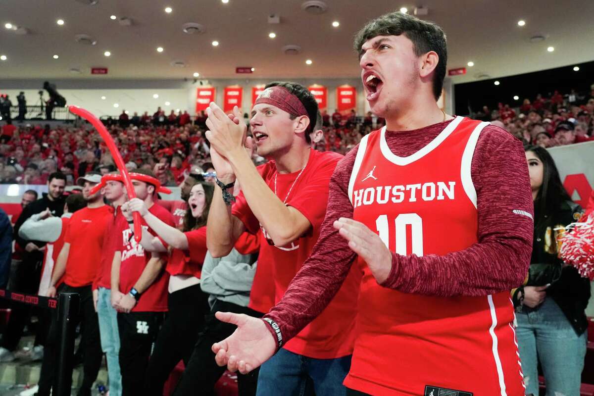 Houston fan Michael Carrara, right, cheers alongside Trevor Stall during the second half of an NCAA college basketball game at the Fertitta Center, Saturday, Jan. 6, 2024, in Houston.