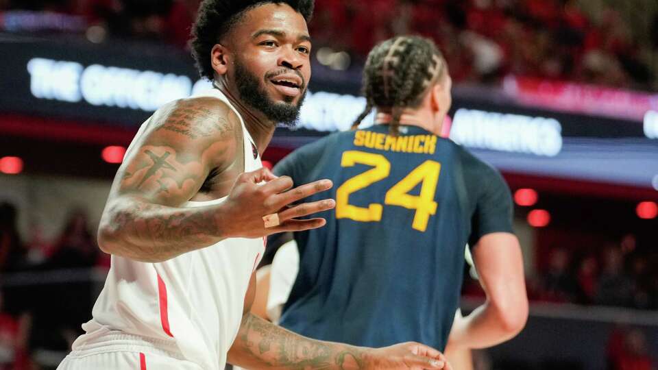 Houston Cougar guard Jamal Shead (1) gestures after assisting on a 3-pointer by guard Damian Dunn during the second half of an NCAA college basketball game at the Fertitta Center, Saturday, Jan. 6, 2024, in Houston.