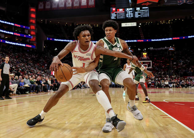 Amen Thompson #1 of the Houston Rockets goes to the basket while defended by MarJon Beauchamp #3 of the Milwaukee Bucks in the first half at Toyota Center on January 06, 2024 in Houston, Texas. 