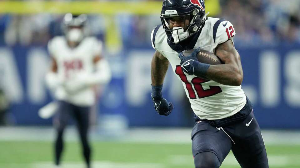 Houston Texans wide receiver Nico Collins (12) picks up a 29-yard gain during the first half of an NFL football game Saturday, Jan. 6, 2024, in Indianapolis.