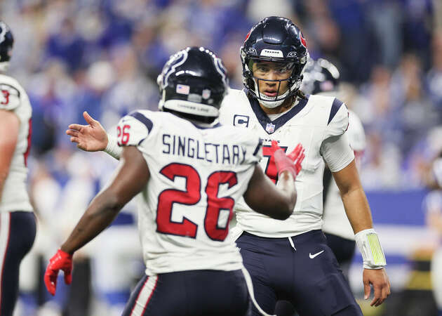 C.J. Stroud #7 and Devin Singletary #26 of the Houston Texans celebrate a touchdown during the fourth quarter against the Indianapolis Colts at Lucas Oil Stadium on January 06, 2024 in Indianapolis, Indiana.