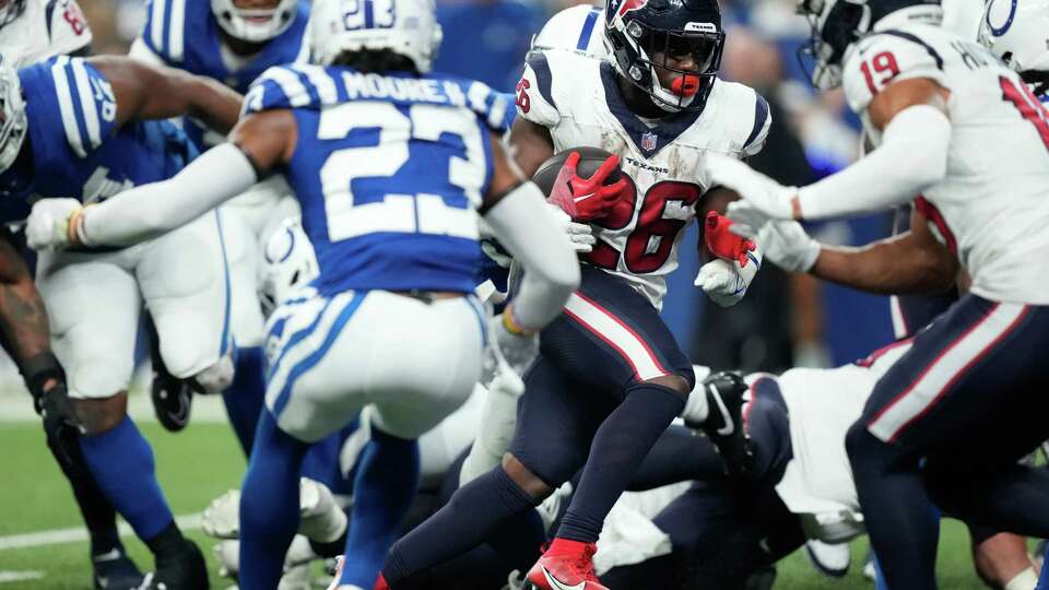 Houston Texans running back Devin Singletary (26) runs for a 3-yard touchdown to take a 23-17 lead during the second half of an NFL football game Saturday, Jan. 6, 2024, in Indianapolis.