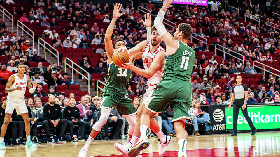 Milwaukee Bucks forward Giannis Antetokoumpo (34), Houston Rockets center Alperen Sengun (28) and Brook Lopez (11) fight for a rebound during the second half of an NBA basketball game Saturday, Jan. 6, 2024, in Houston.