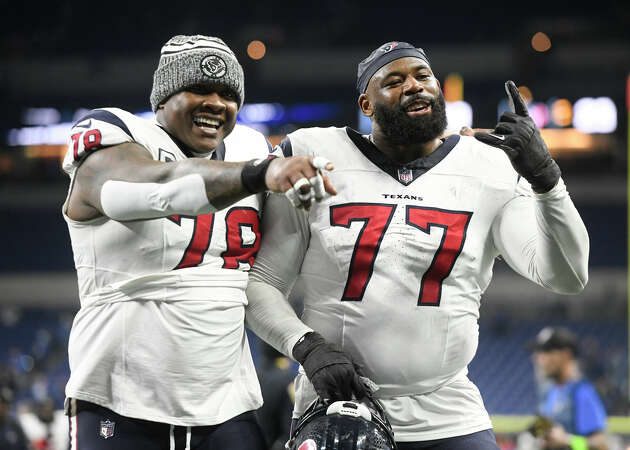 Houston Texans Offensive Tackle George Fant (77) and Houston Texans Offensive Tackle Laremy Tunsil (78) celebrate after the NFL game between the Houston Texans and the Indianapolis Colts on January 6, 2024, at Lucas Oil Stadium in Indianapolis, Indiana.