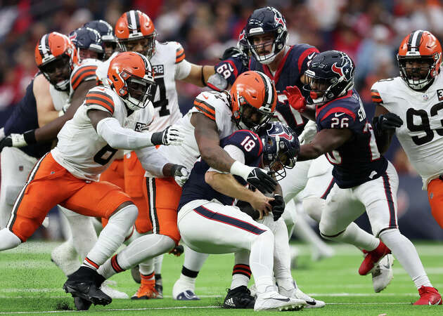 Case Keenum #18 of the Houston Texans is sacked by Alex Wright #91 of the Cleveland Browns during the second quarter at NRG Stadium on December 24, 2023 in Houston, Texas. 