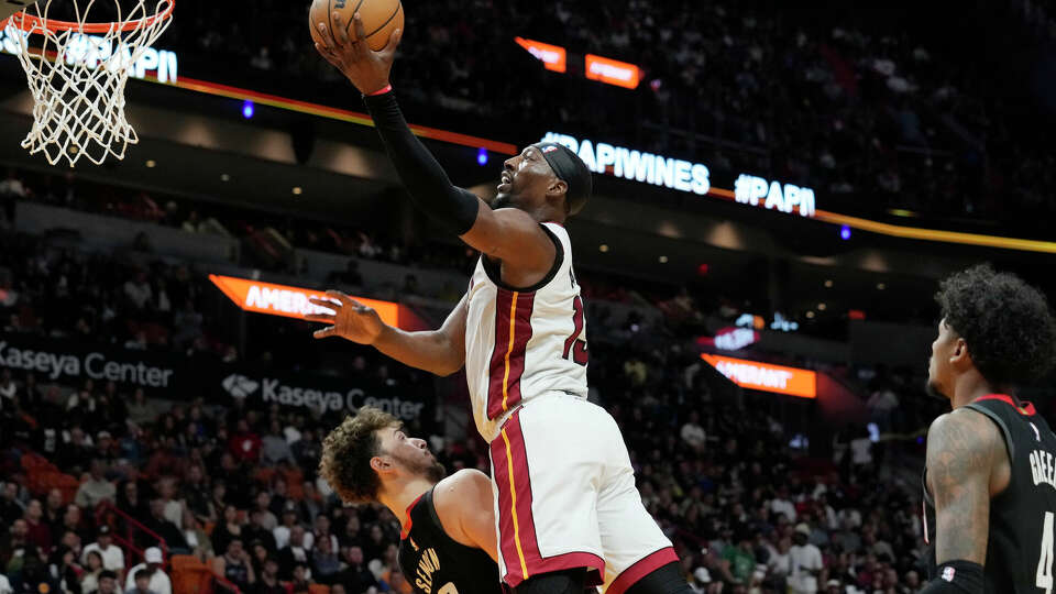 Miami Heat center Bam Adebayo (13) drives to the basket over Houston Rockets center Alperen Sengun (28) during the first half of an NBA basketball game, Monday, Jan. 8, 2024, in Miami. (AP Photo/Marta Lavandier)