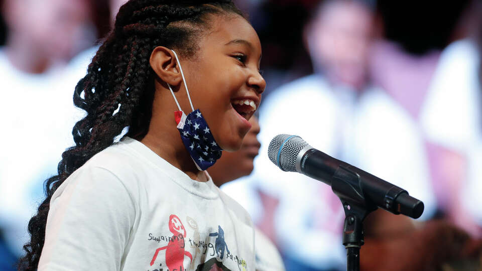 Members of the MLK Youth Mass Choir sing during the 