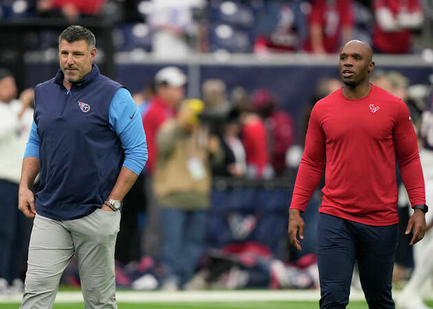 Tennessee Titans head coach Mike Vrabel, left, and Houston Texans head coach DeMeco Ryans, right, walk across the field before an NFL football game Sunday, Dec. 31, 2023, in Houston. 