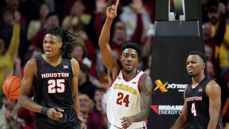 Iowa State forward Hason Ward (24) celebrates between Houston forward Joseph Tugler (25) and guard L.J. Cryer (4) after making a basket during the first half of an NCAA college basketball game, Tuesday, Jan. 9, 2024, in Ames, Iowa. (AP Photo/Charlie Neibergall)