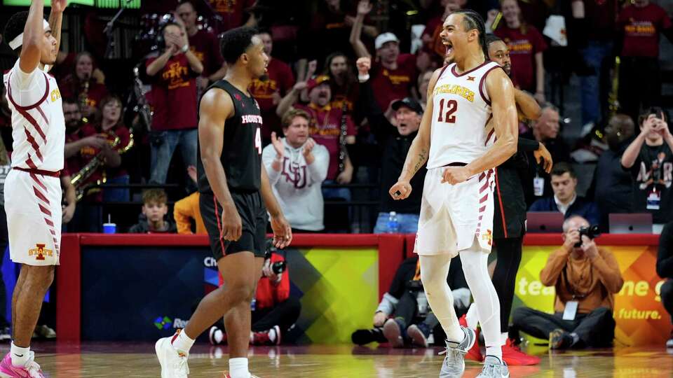 Iowa State forward Robert Jones (12) celebrates in front of Houston guard L.J. Cryer (4) at the end of an NCAA college basketball game, Tuesday, Jan. 9, 2024, in Ames, Iowa. Iowa State won 57-53. (AP Photo/Charlie Neibergall)