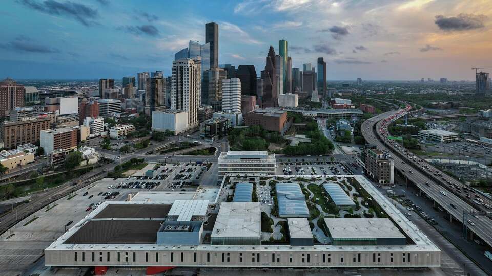 An aerial view of Post Houston with downtown Houston skyline in the background.