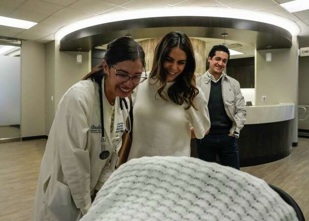 MD Director of cardio- obstetrics Valeria Duarte, 39, Lourdes Arias-Salbes, 35, and her husband Rolando Gerez, 41, look at their new born son,Jose Alejandro Gerez just before a doctors visit on Tuesday, Jan. 9, 2024, at Houston Methodist Hospital in Houston.