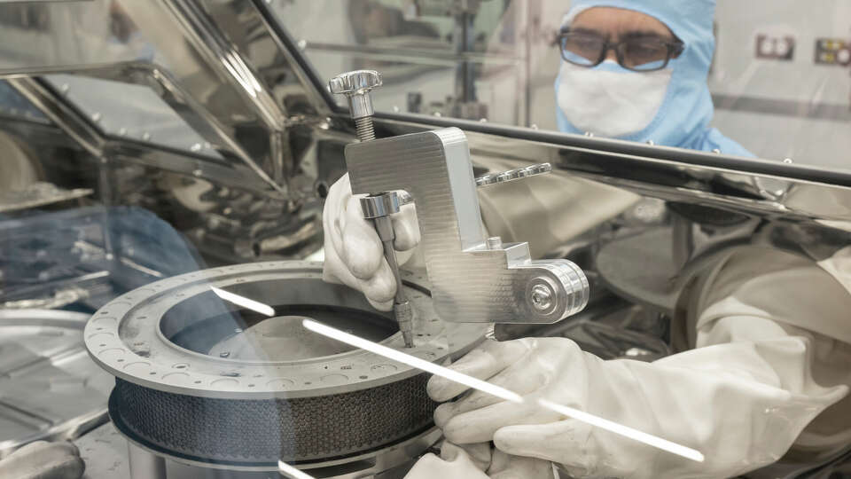 NASA's OSIRIS-REx curation engineer, Neftali Hernandez, attaches one of the tools developed to help remove two final fasteners that prohibited complete disassembly of the TAGSAM (Touch-and-Go Sample Acquisition Mechanism) head that holds the remainder of material collected from asteroid Bennu. Engineers on the team, based at NASA's Johnson Space Center in Houston, developed new tools that freed the fasteners on Jan. 10. 