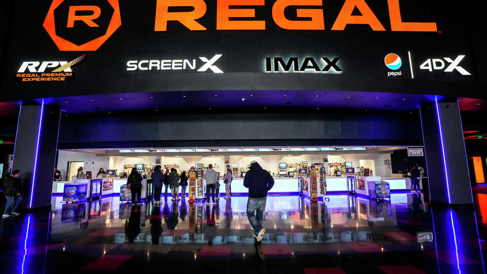 Movie goers line up at the stack bar at Regal MarqE Cinema 