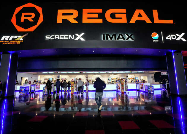 Movie goers line up at the stack bar at Regal MarqE Cinema 