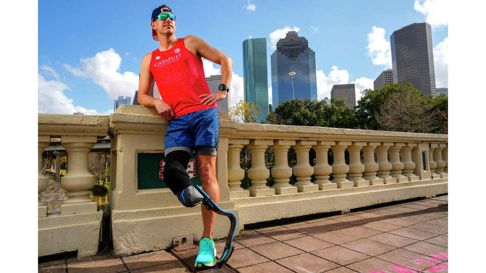 Marathon runner Jeff Waldmuller poses for a portrait on the Sabine Street Bridge on Thursday, Jan. 11, 2024 in Houston. In December of 2008, Waldmuller was on his way home to Wichita Falls for Christmas break from the University of Houston when he was involved in an accident with a semi while riding a motorcycle. His leg was amputated in 2009 and now runs endurance races on a regular basis. He will compete in the Chevron Houston Marathon in the amputee division.