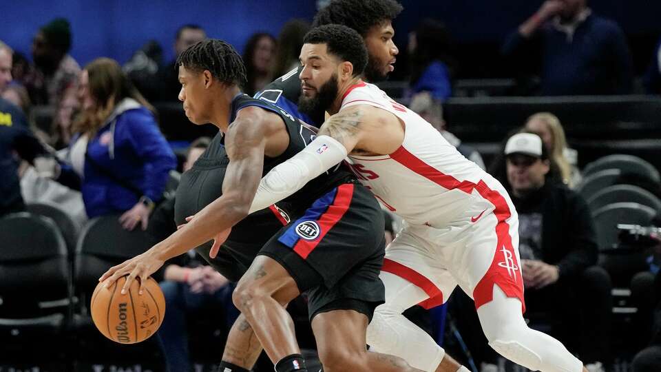 Houston Rockets guard Fred VanVleet (23) reaches in on Detroit Pistons guard Marcus Sasser during the first half of an NBA basketball game, Friday, Jan. 12, 2024, in Detroit. (AP Photo/Carlos Osorio)