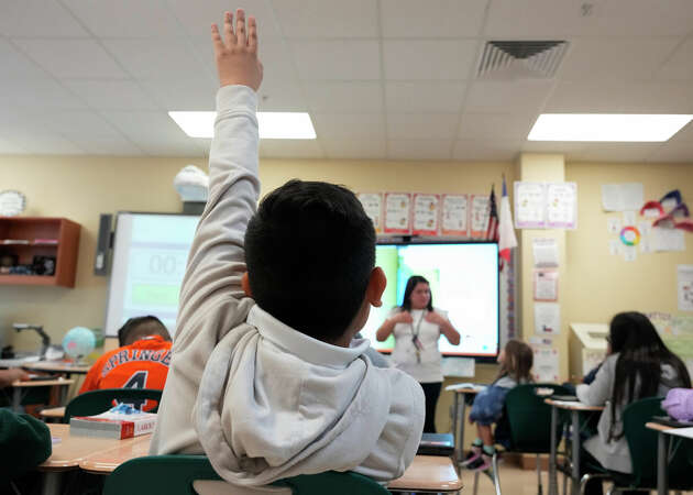 A fourth-grade Dual Language student raises his hand during class in Spanish on Thursday, Oct. 19, 2023 at Patterson Elementary School in Houston. 