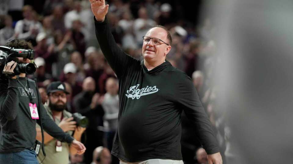 Texas A&M head football coach Mike Elko waves to the crowd at Reed arena during a timeout of an NCAA college basketball game between Texas A&M and Kentucky on Saturday, Jan. 13, 2024, in College Station, Texas. (AP Photo/Sam Craft)